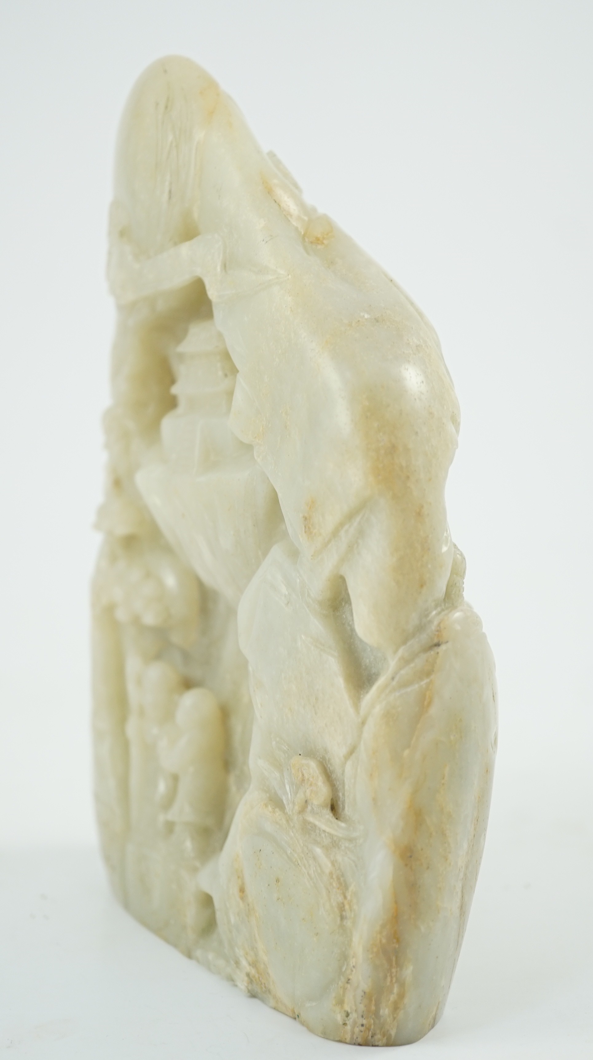 A Chinese pale celadon jade boulder carving, 21cm high 15.5cm wide